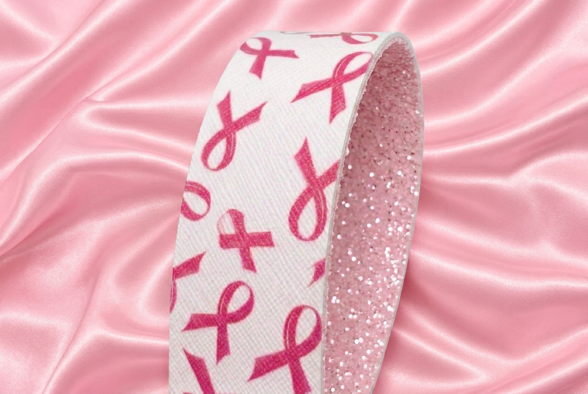 Wristlet with pink ribbon fabric on a pink satin background